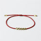 Bracelet tibétain multicolore posé sur une surface en bois