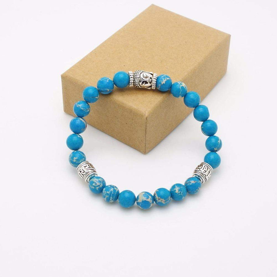 Bracelet bleu et argenté sur fond blanc