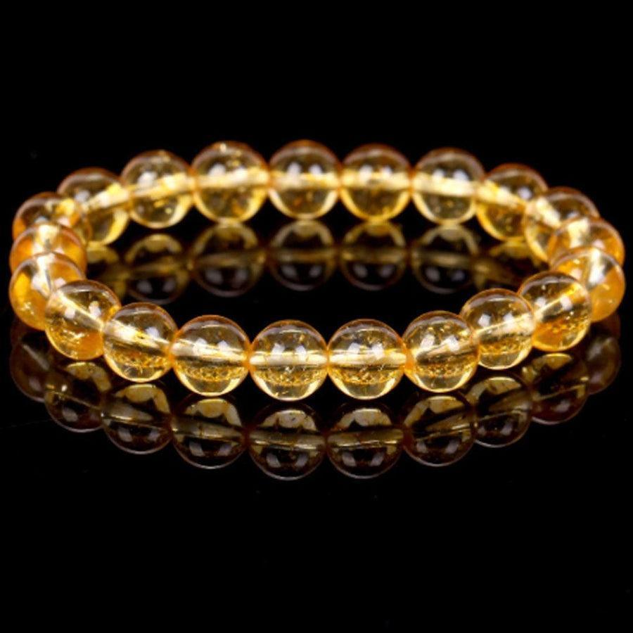Bracelet en citrine posé sur une surface claire