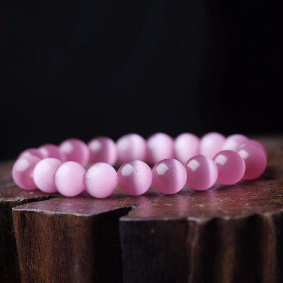 Bracelet en opale rose enroulé, montrant sa flexibilité