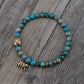 Bracelet en perles de turquoise avec symbole Bouddha