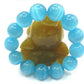 Détail des perles d'opalite bleue, éclat et transparence