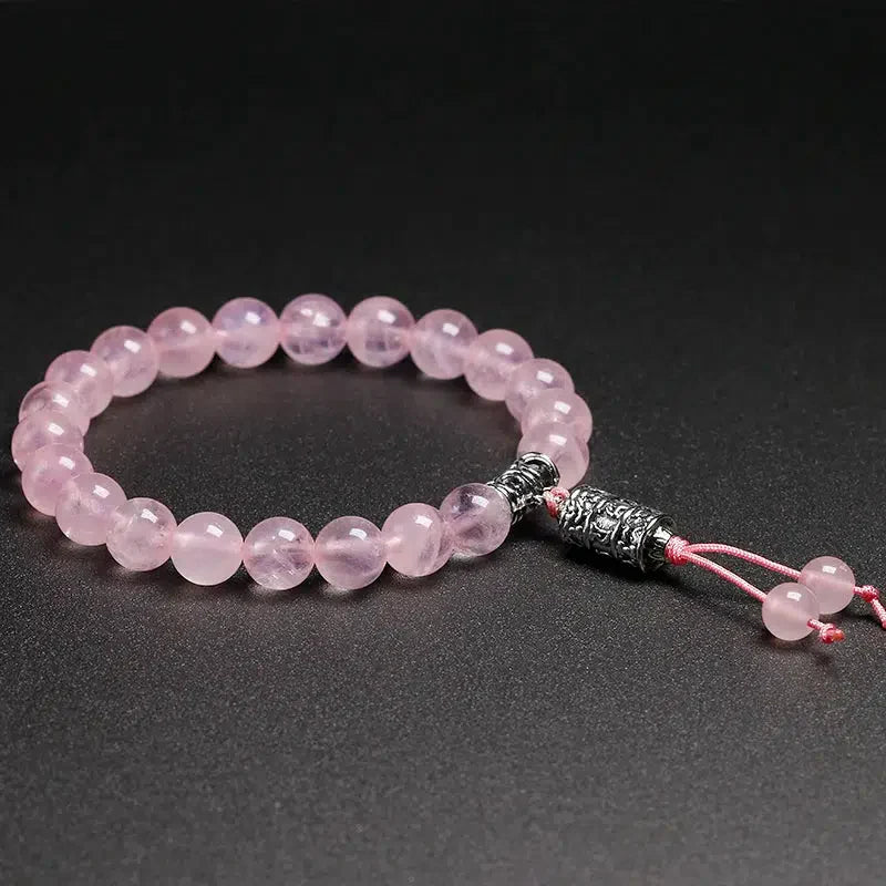 Bracelet en quartz rose avec perle centrale Om