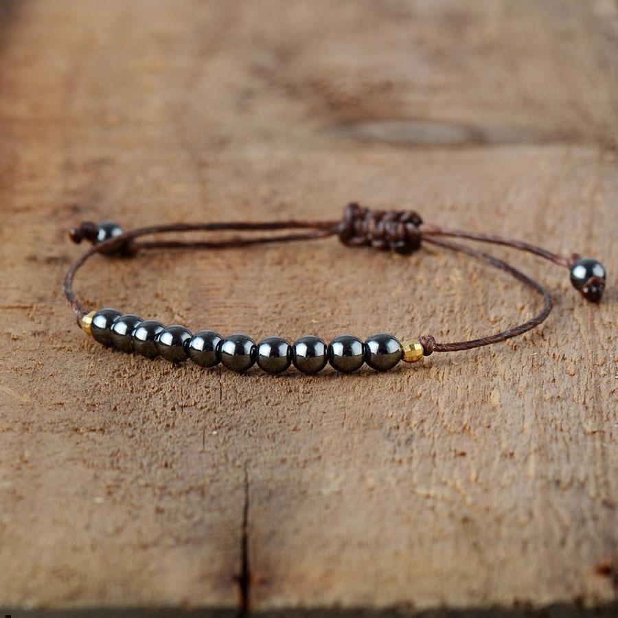 Bracelet en hématite avec perles dorées sur fond blanc