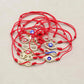 Bracelet rouge avec symbole infini et œil protecteur