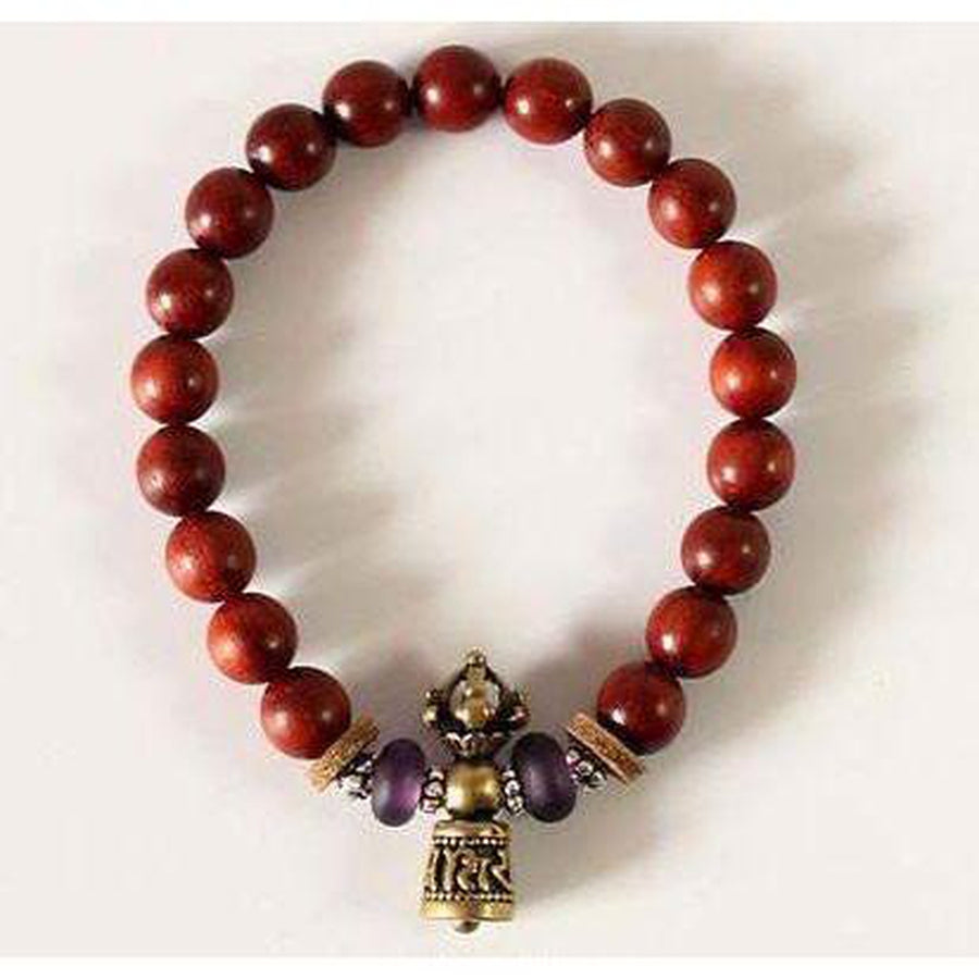 Clochette en cuivre blanc avec mantra sur le bracelet