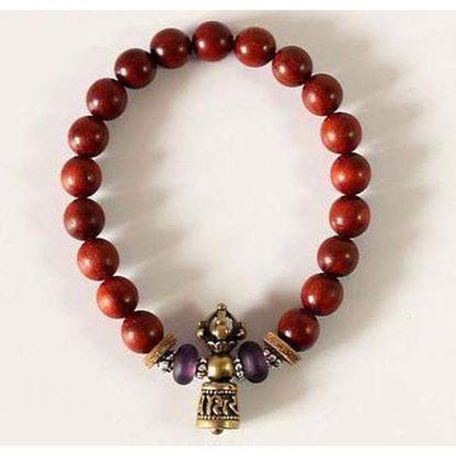 Clochette en cuivre blanc avec mantra sur le bracelet