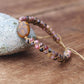 Bracelet Shamballa en jaspe et rhodonite sur fond blanc