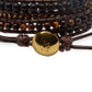 Gros plan sur les perles du bracelet en Œil de Tigre