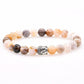 Bracelet en onyx multicolore avec tête de Bouddha dorée