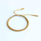 Détail d'un nœud coulissant sur bracelet tressé