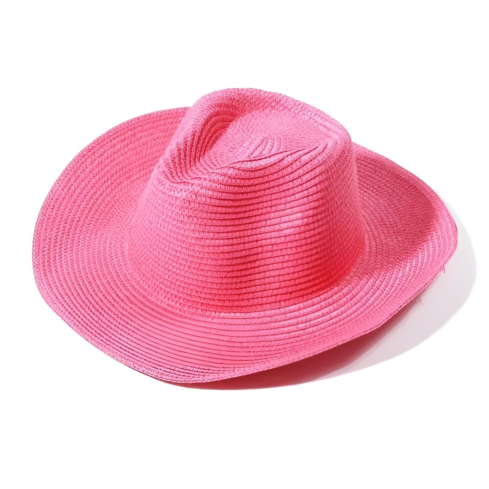 Chapeau de paille coloré posé sur une nappe blanche