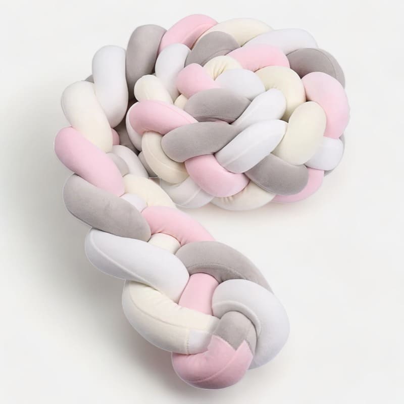Coussin tressé rose pour protection lit bébé
