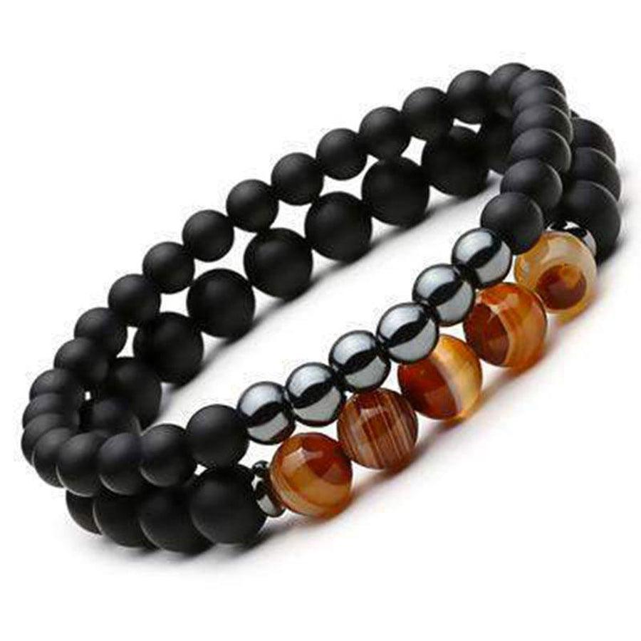 Bracelets unisexes en onyx, posés sur une surface claire