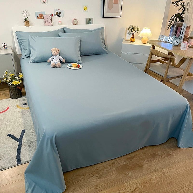 Draps housse bleu ciel en coton respirant sur lit