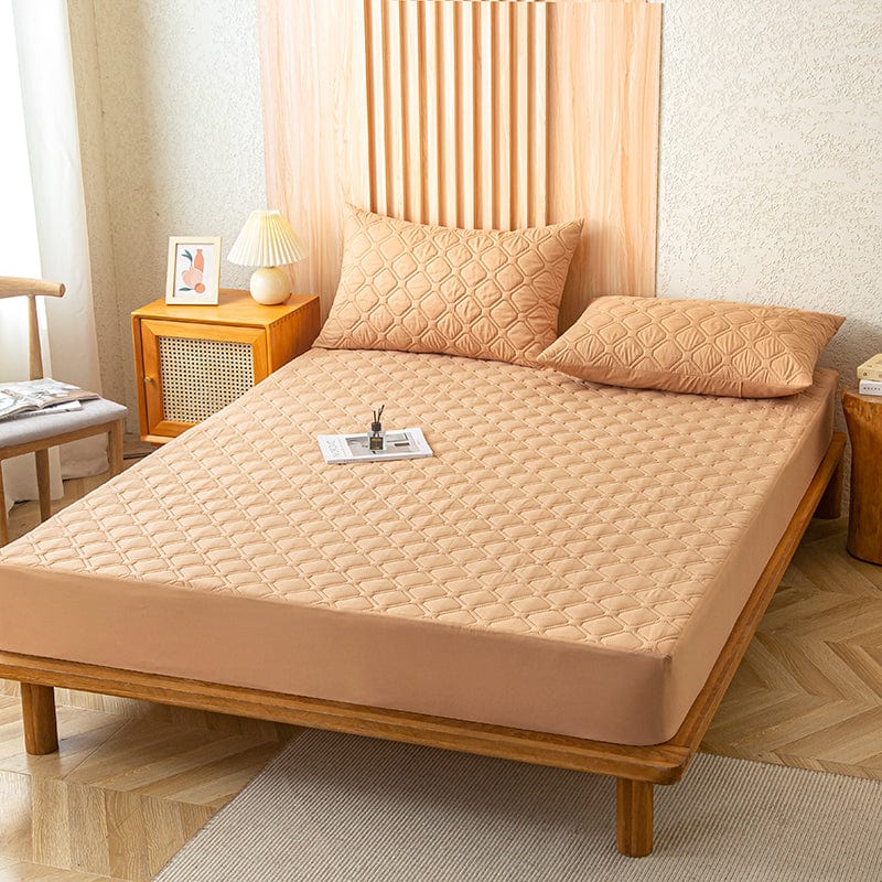 Drap housse orange sur un lit, vue de dessus