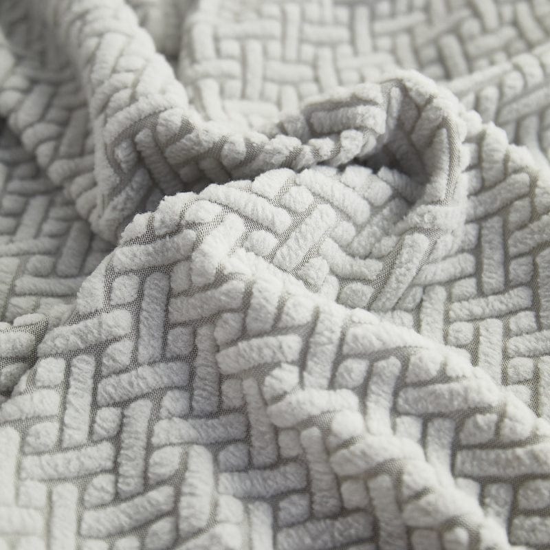 Coussin recouvert de housse polaire grise, vue de dessus