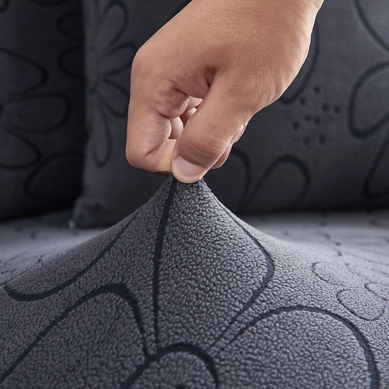 Housse polaire grise avec motif floral sur coussin de canapé