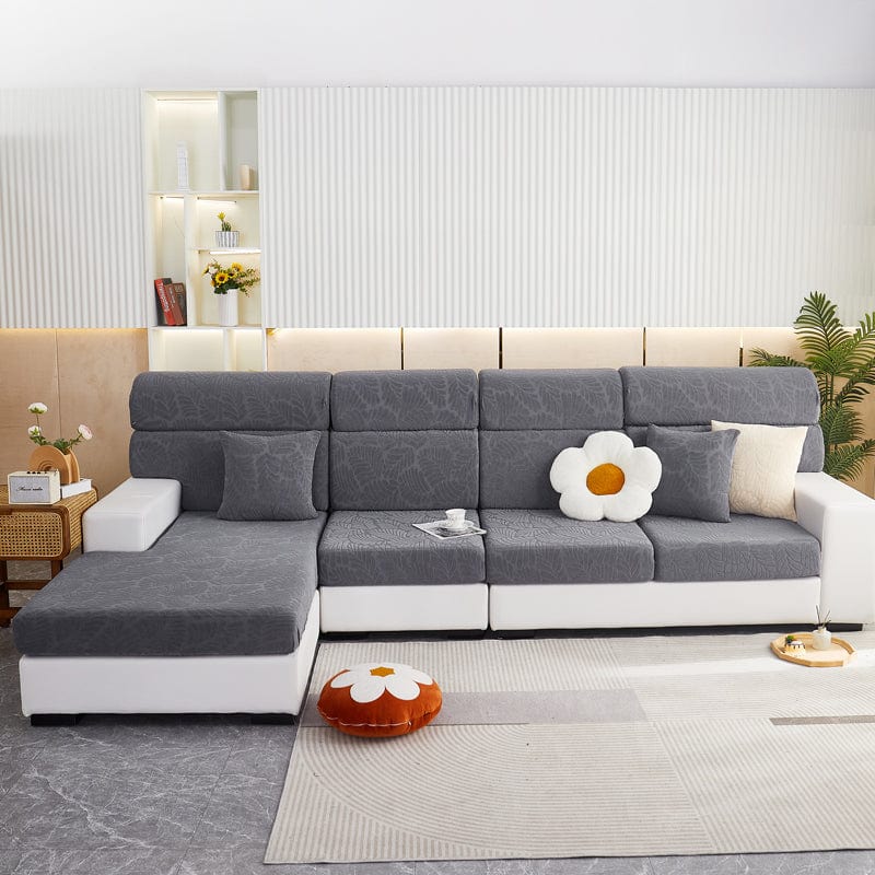 Housse grise avec motifs, ajustée sur coussin de canapé
