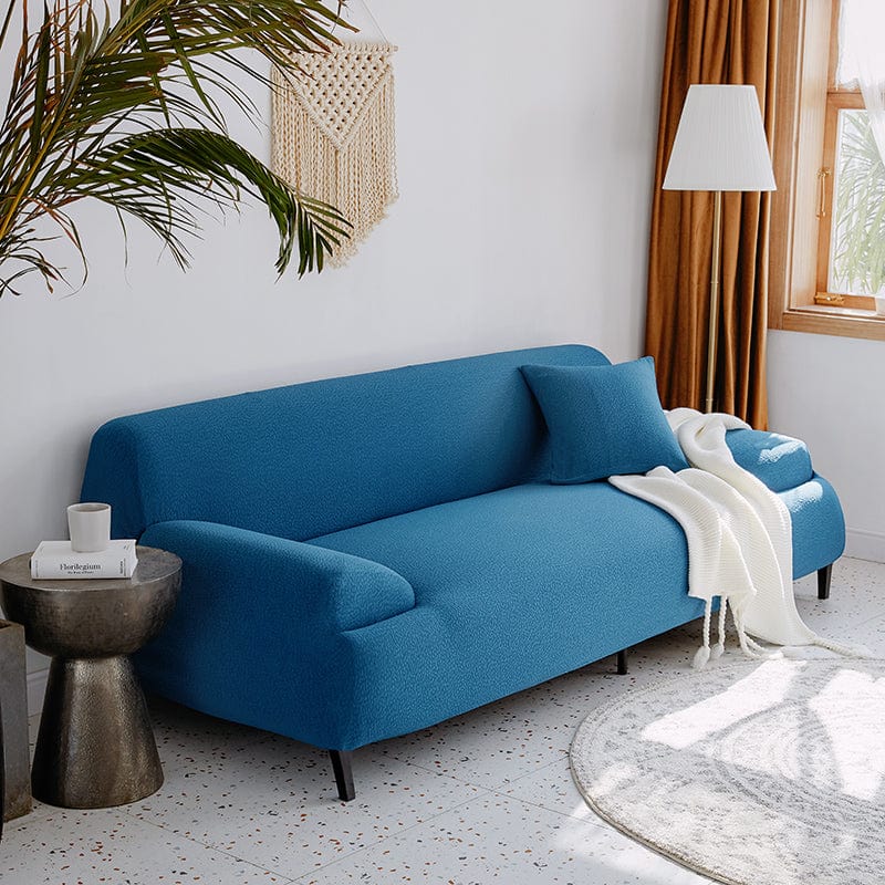 Housse extensible s'adaptant à un canapé d'angle