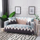 Housse extensible grise sur canapé droit moderne