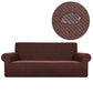 Housse extensible marron couvrant un canapé d'angle