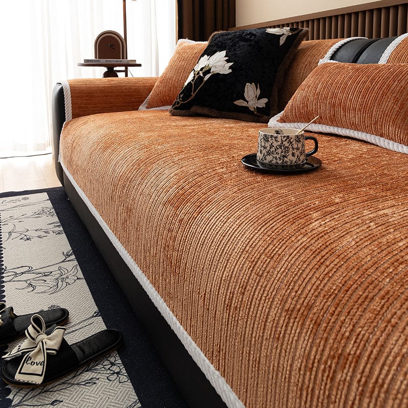 Vue latérale d'un canapé recouvert de tissu chenille orange