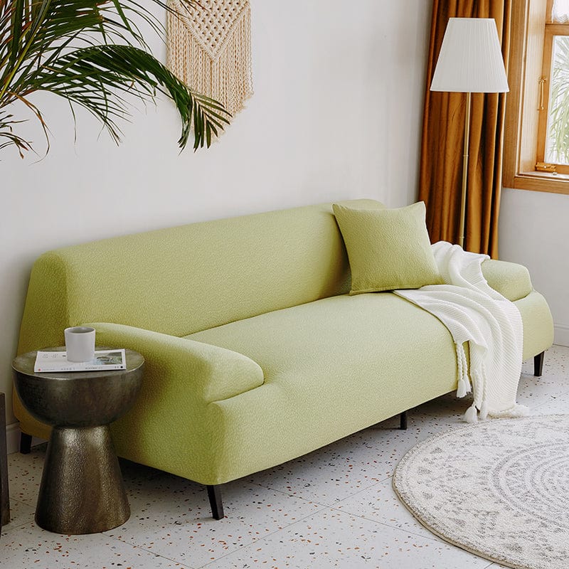 Housse extensible couvrant un canapé droit