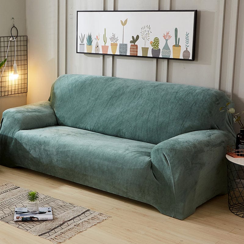 Housse en velours vert sur canapé trois places