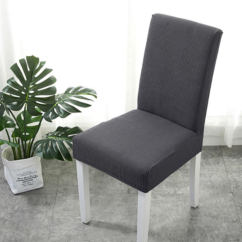Housse de chaise grise installée sur une chaise standard