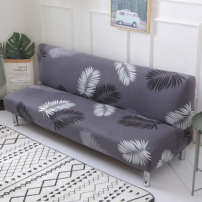 Vue de côté d'un canapé-lit avec housse élastique grise