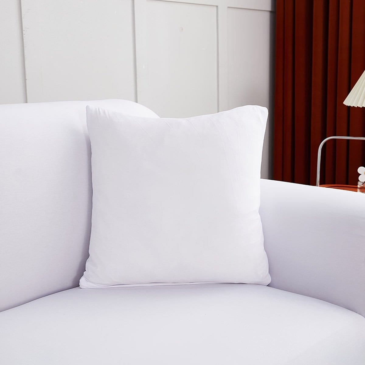 Deux housses de coussin blanches sur un canapé moderne