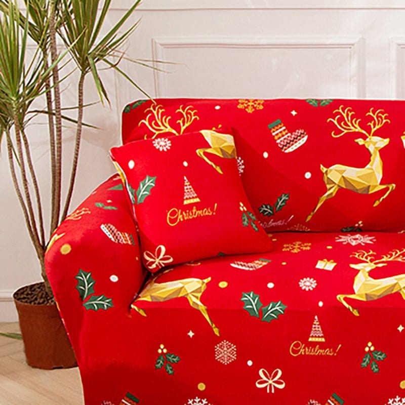 Deux housses de coussin dorées à motif de Noël sur canapé