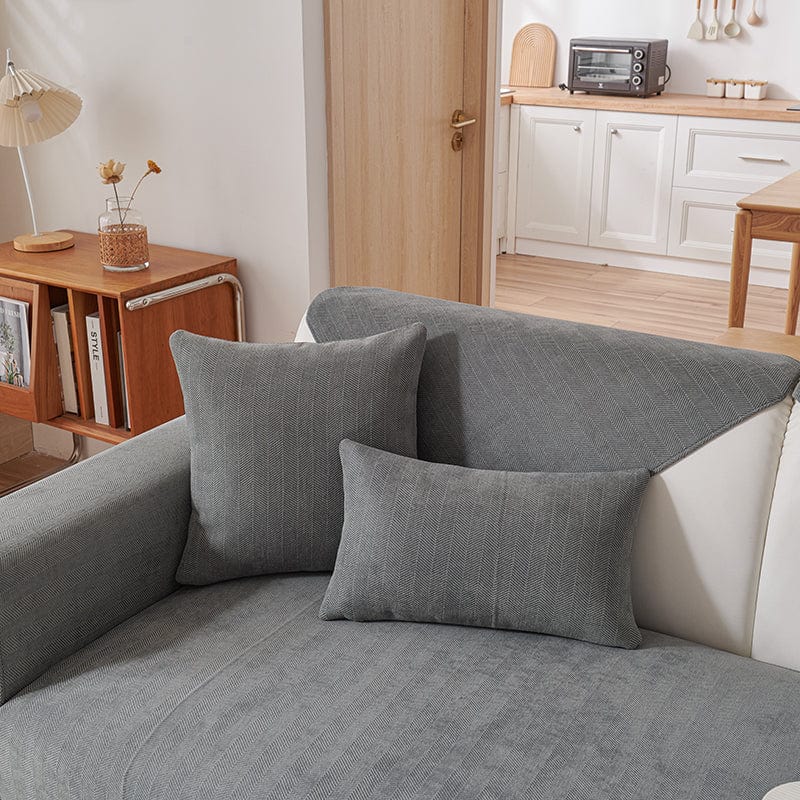 Housse de coussin gris en tissu chenillé sur canapé