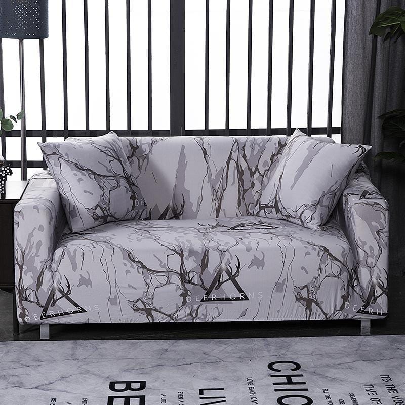 Housses de coussin marbrées extensibles sur canapé gris