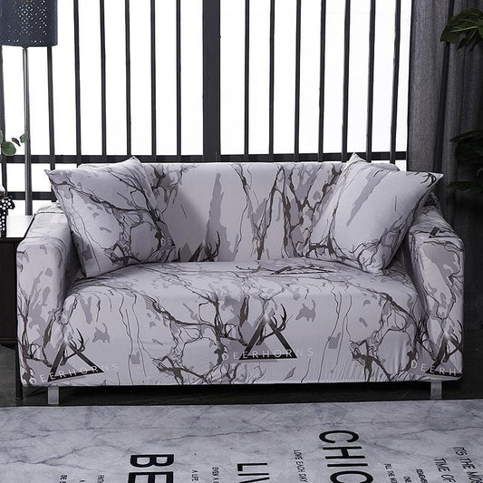 Housses de coussin marbrées extensibles sur canapé gris