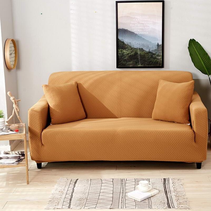 Housse de coussin orange sur canapé, tissu déperlant