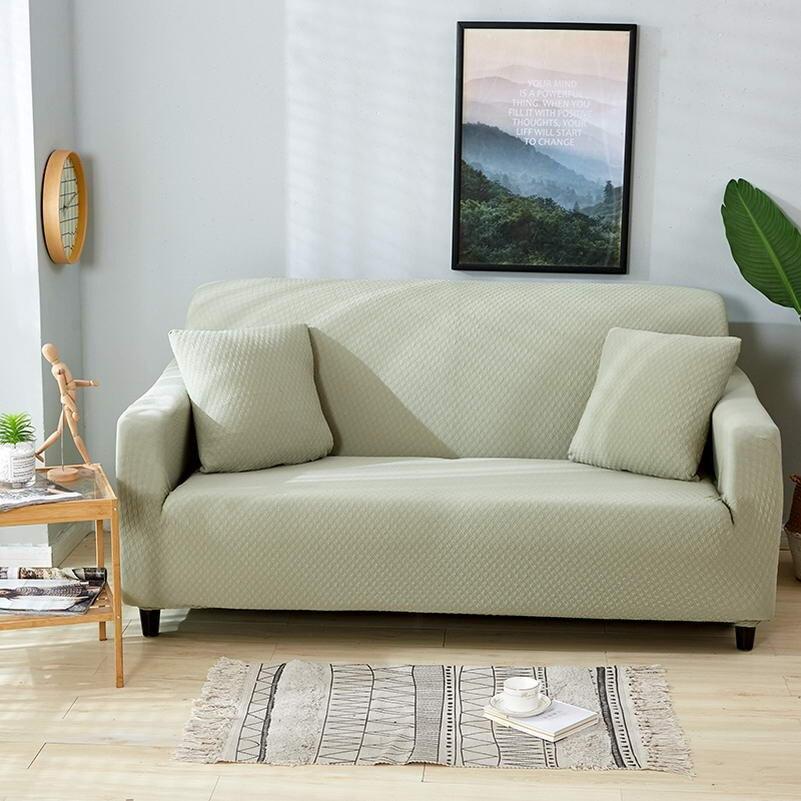 Housse de coussin verte imperméable sur canapé beige