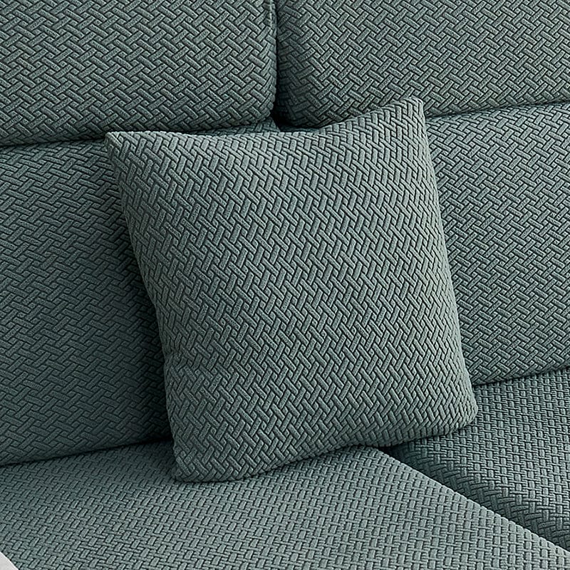 Housse de coussin verte en laine avec motif géométrique