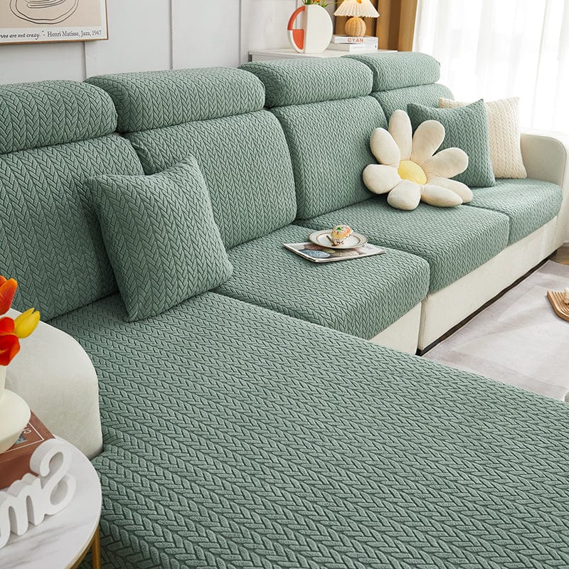 Housse de coussin verte en laine avec motif géométrique