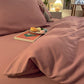 Housse de couette rose étalée sur un lit, ambiance cosy