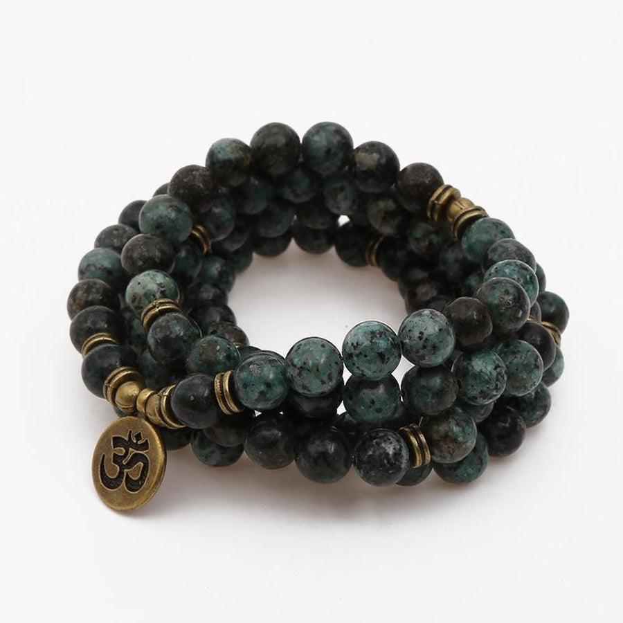 Mala en turquoises africaines avec charme lotus