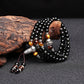 Mala en obsidienne et œil de tigre avec tête de Bouddha