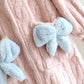 Détail des boutons et nœuds sur les poches du peignoir