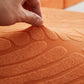 Housse polaire orange avec motif palmier sur canapé