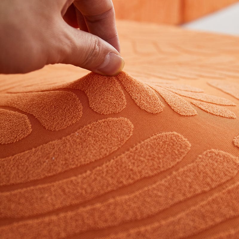 Housse polaire orange avec motif palmier sur canapé