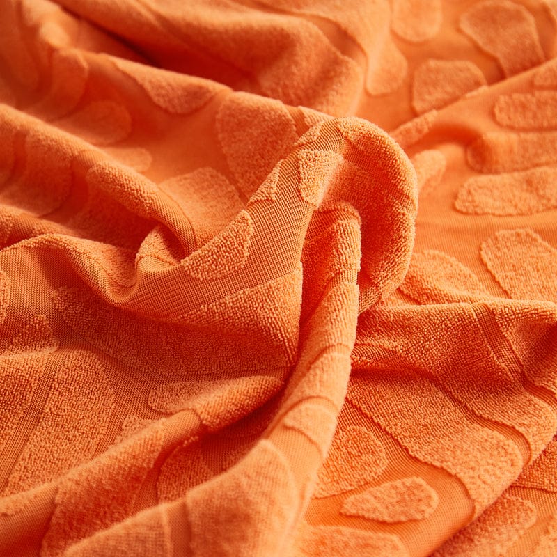 Détail du motif palmier sur housse polaire orange