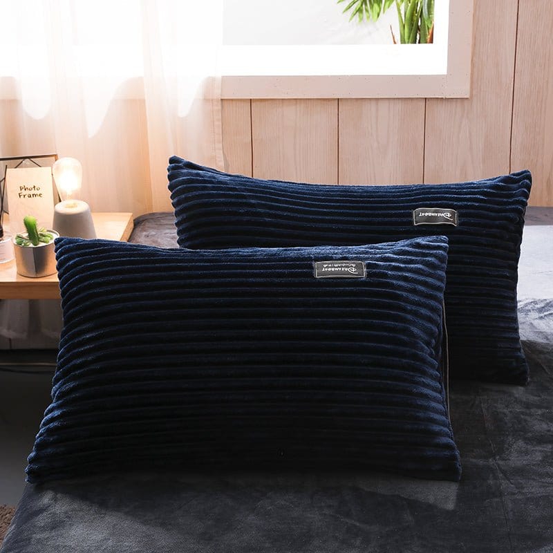Parure de lit en velours bleu marine sur un lit