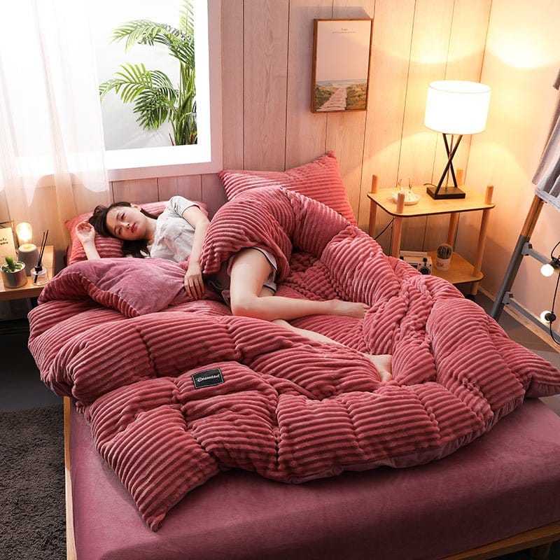 Housse de couette en velours rose sur lit avec oreillers assortis