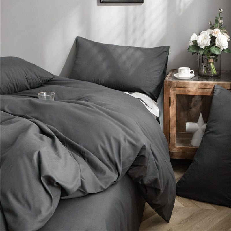 Taies d'oreiller grises avec un motif subtil sur un lit